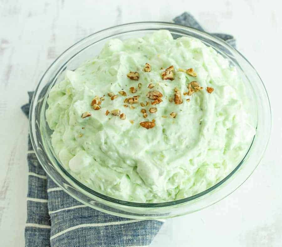 close up of pistachio salad with walnuts on top.