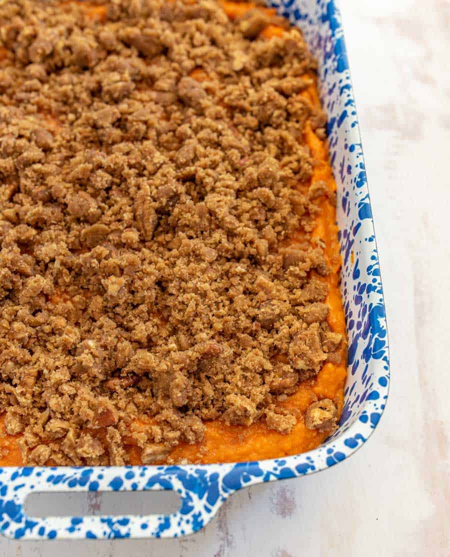 sweet potato casserole in a white and blue pan.