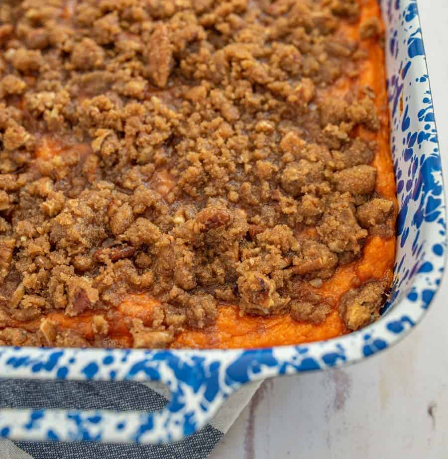 close up of sweet potato casserole in a blue and white pan.
