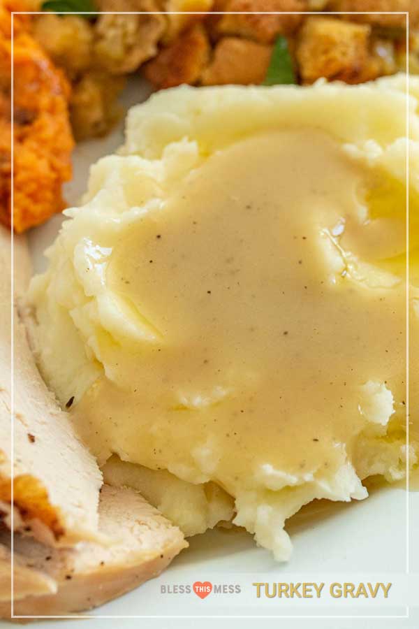Close-up of a scoop of mashed potatoes topped with homemade turkey gravy.