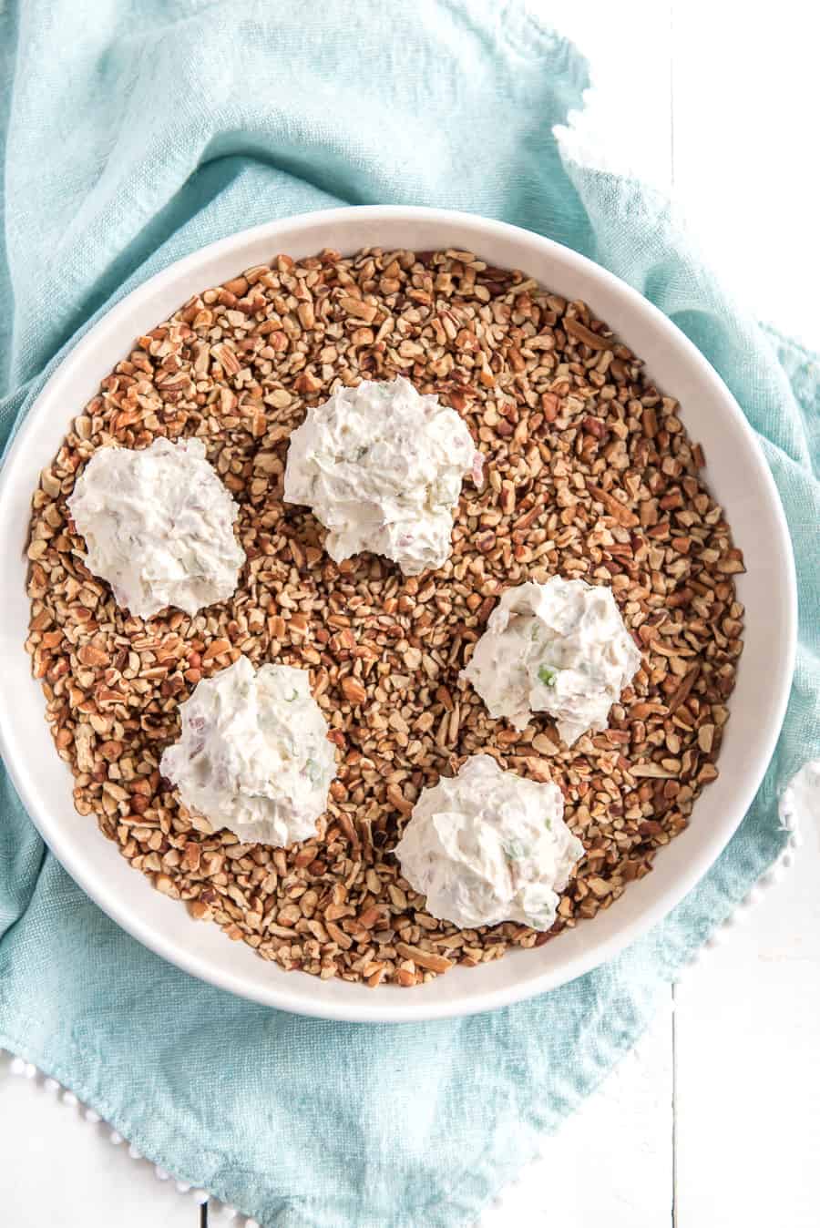 cream cheese going into cooked ground beef for the meat and onion cheese ball