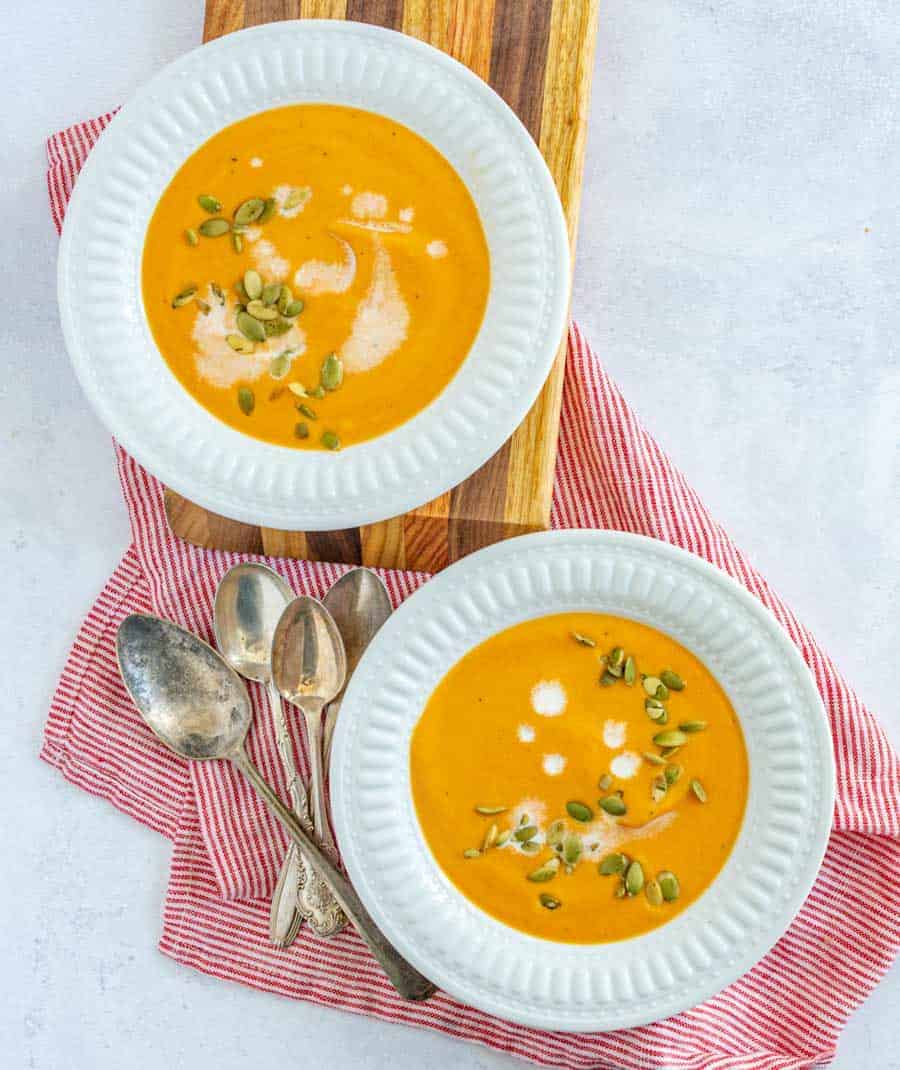 two bowls of creamy carrot soup.