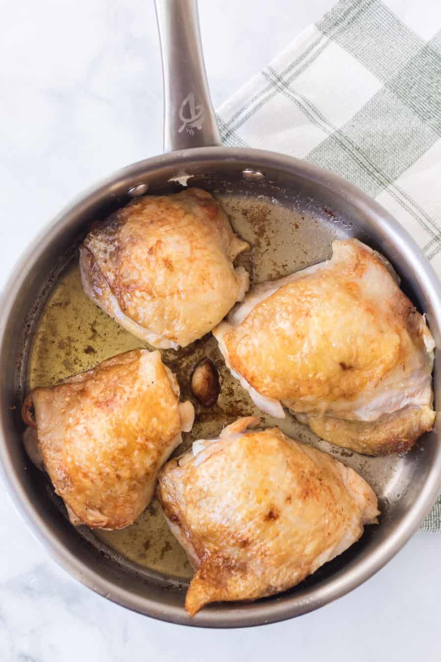 chicken in a pan roasting.