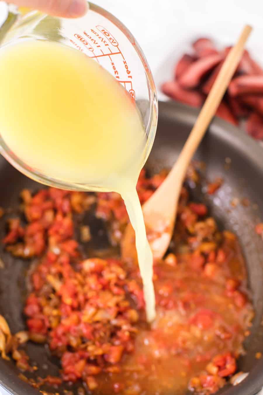 lentils and a tomato and spicy looking sauce in a pan.