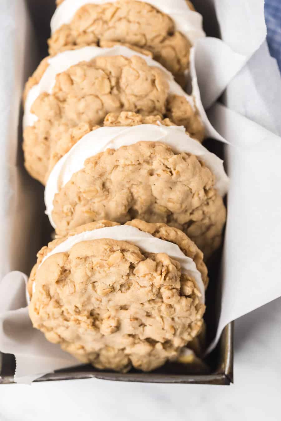 pan of homemade oatmeal cream pie cookies on parchment.