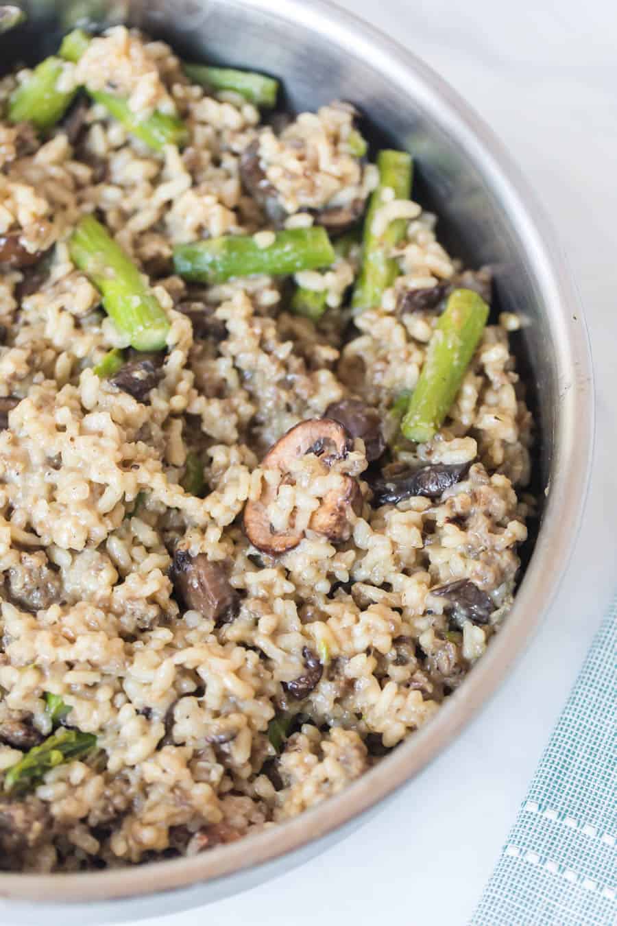 closeup image of Sausage Asparagus and Mushroom Risotto in pan.