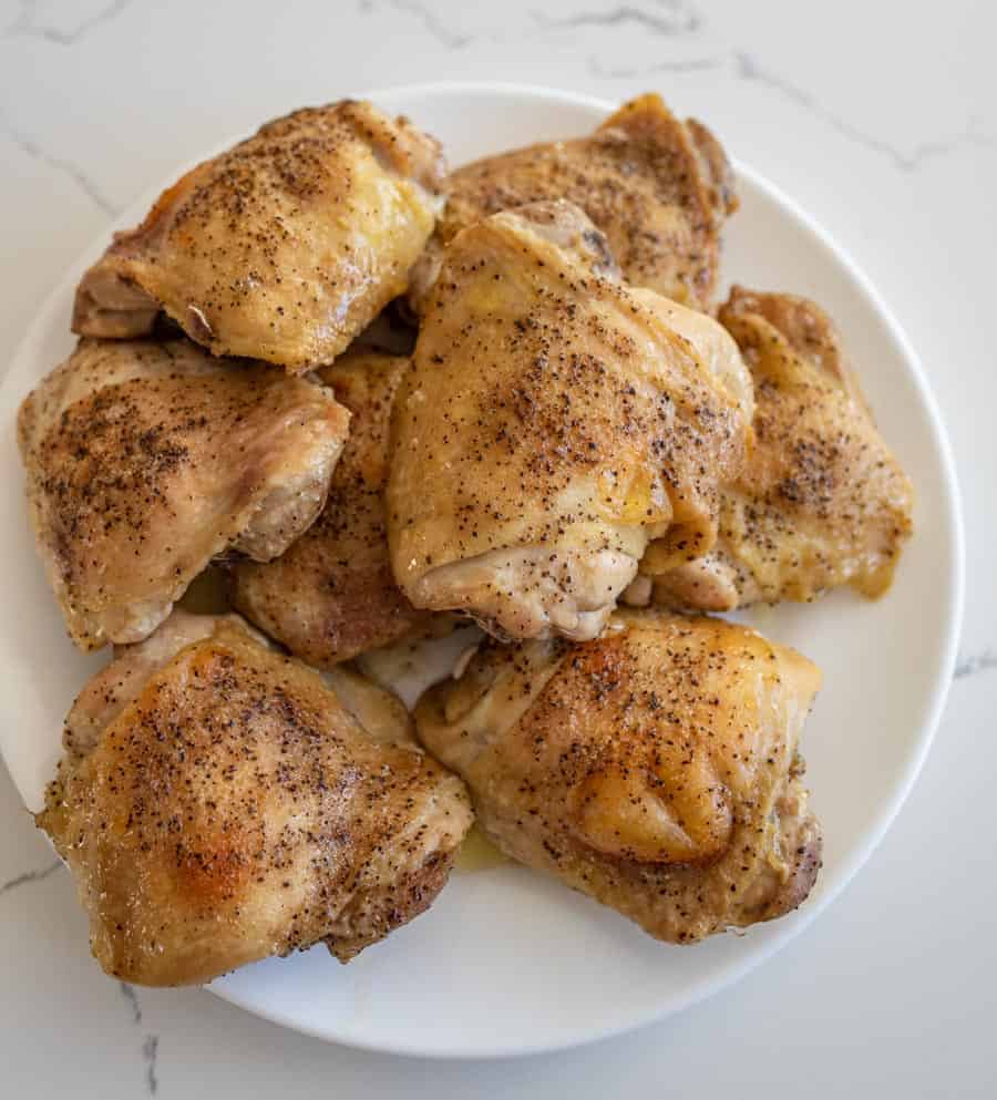 a pile of seasoned and cooked oven baked chicken thighs.