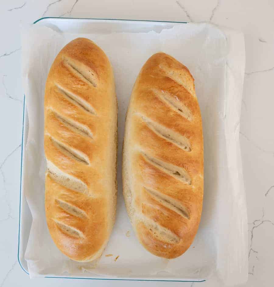two loaves of french bread on parchment paper