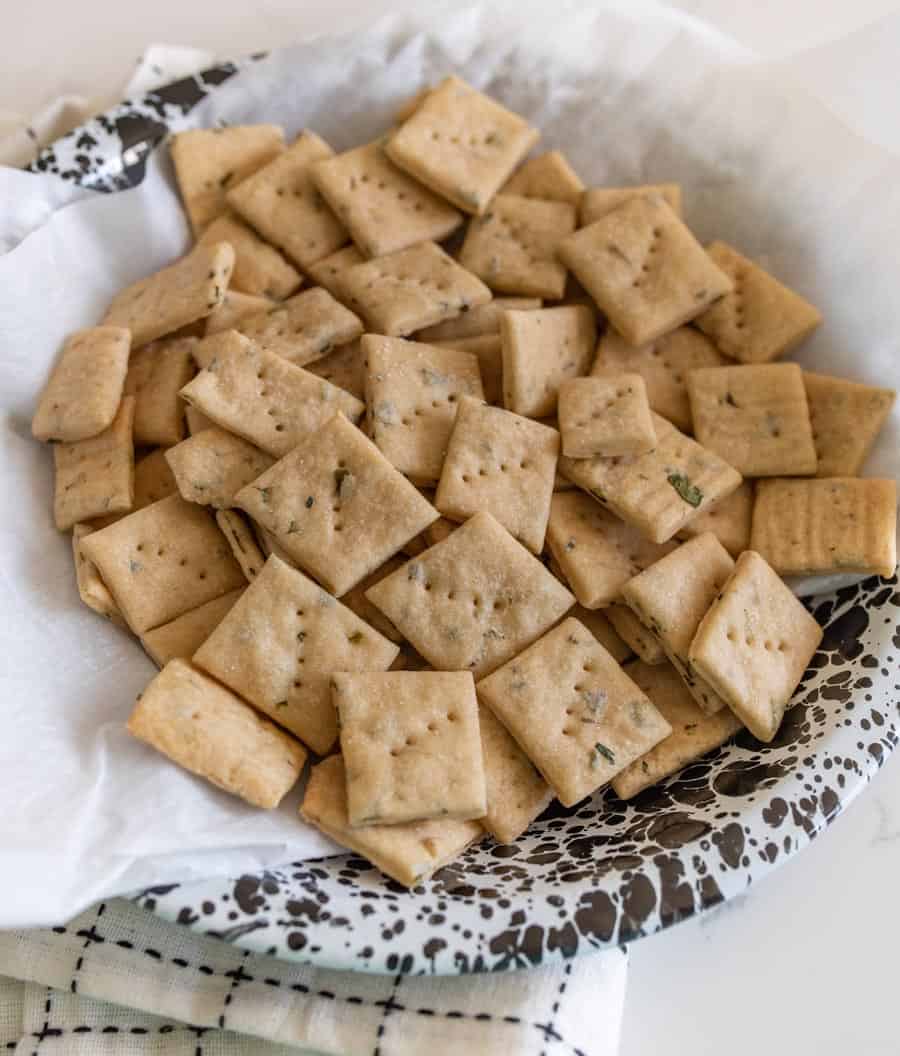 close up of baked sourdough crackers in a serving dish.