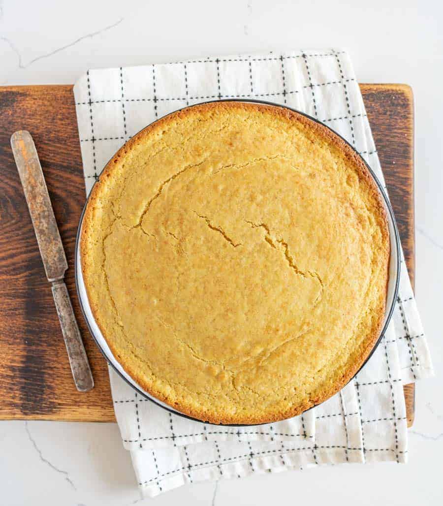 round pan of sourdough cornbread on cutting board