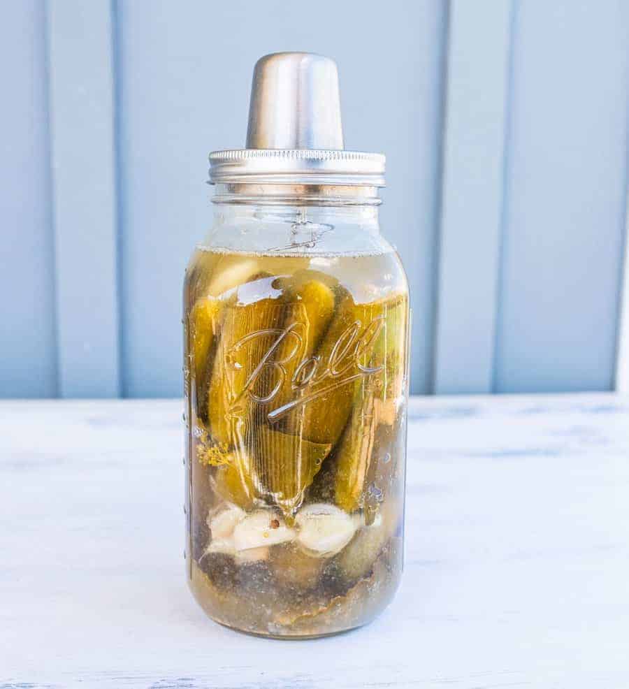 Jar of pickles with fermenting cap on.