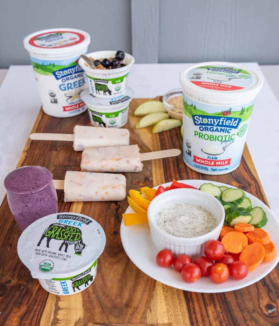 Side angle of healthy snacks for kids on a wooden board.