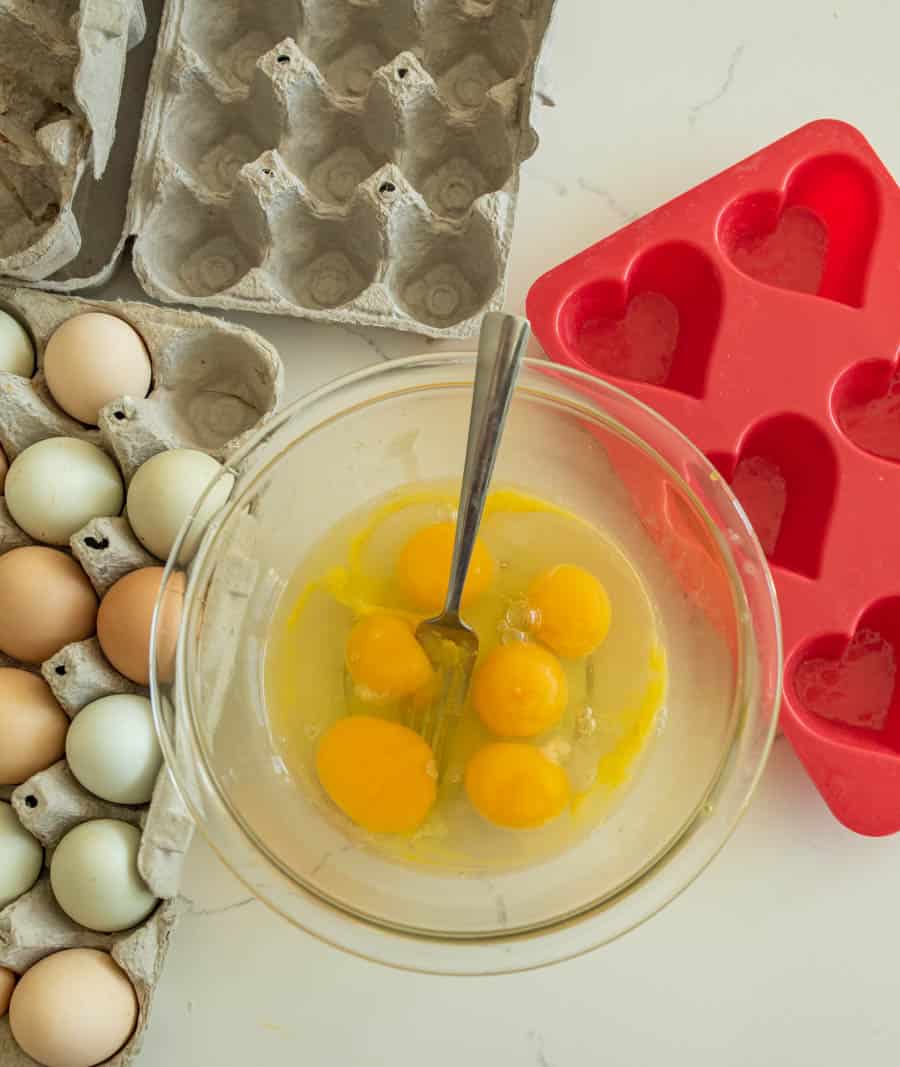 raw eggs before being scrambled in glass bowl