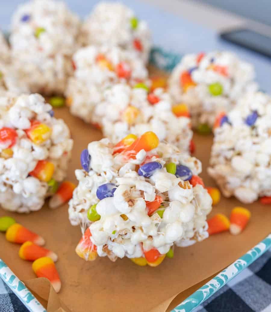 Close-up of a Halloween popcorn balls with candy corn and M&Ms.