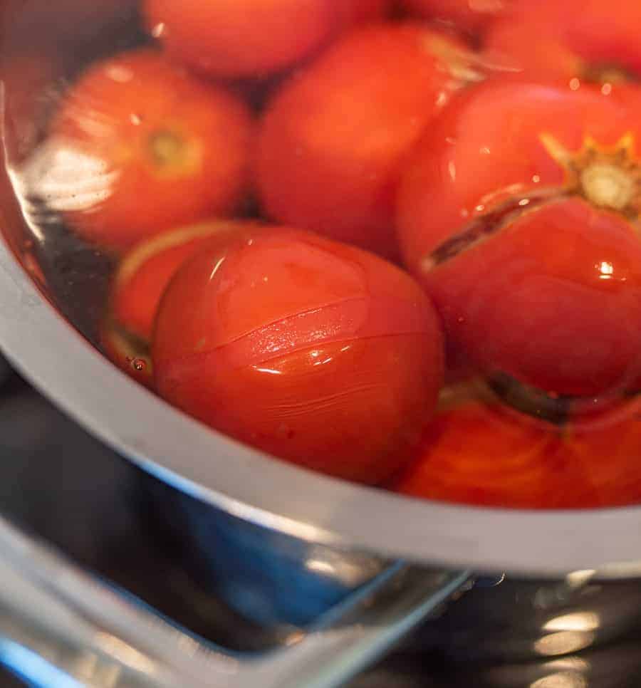 fresh tomatoes in a pot boiling.