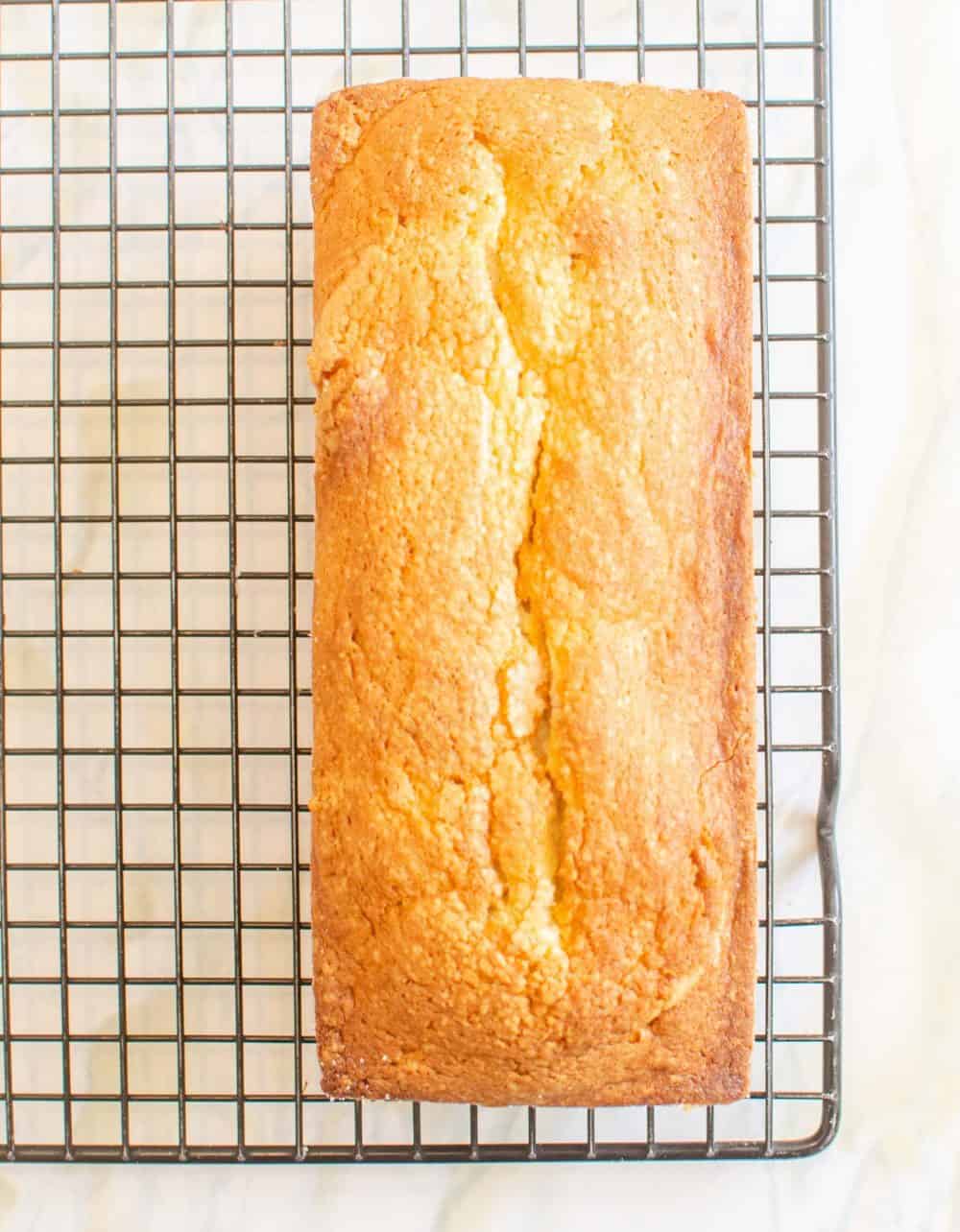 Top view of a pound cake on a cooling rack.