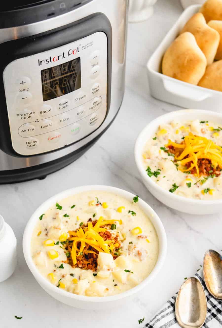 Two bowls of potato soup with the Instant pot in the background.