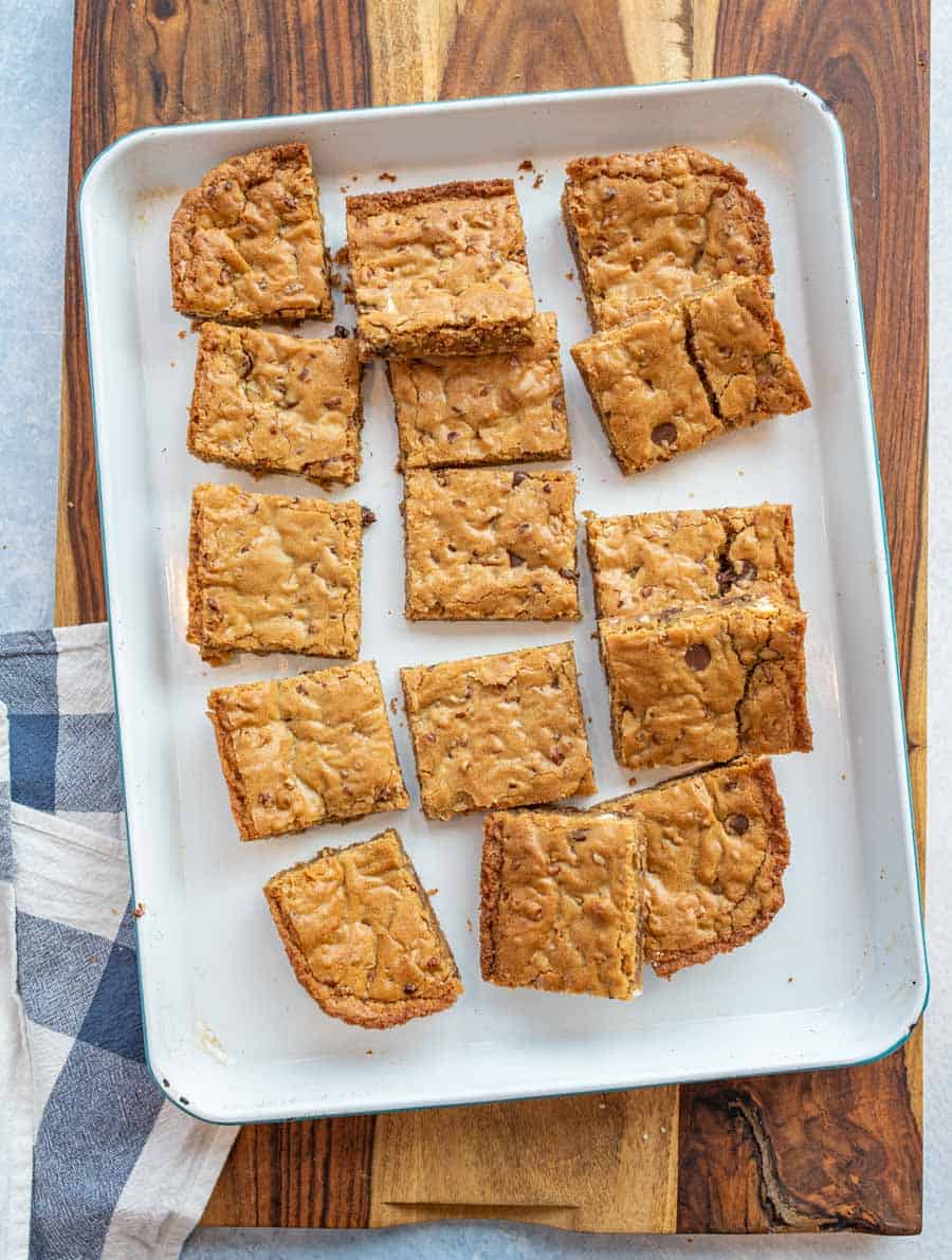 A top view of blondies cut into squares on a tray.