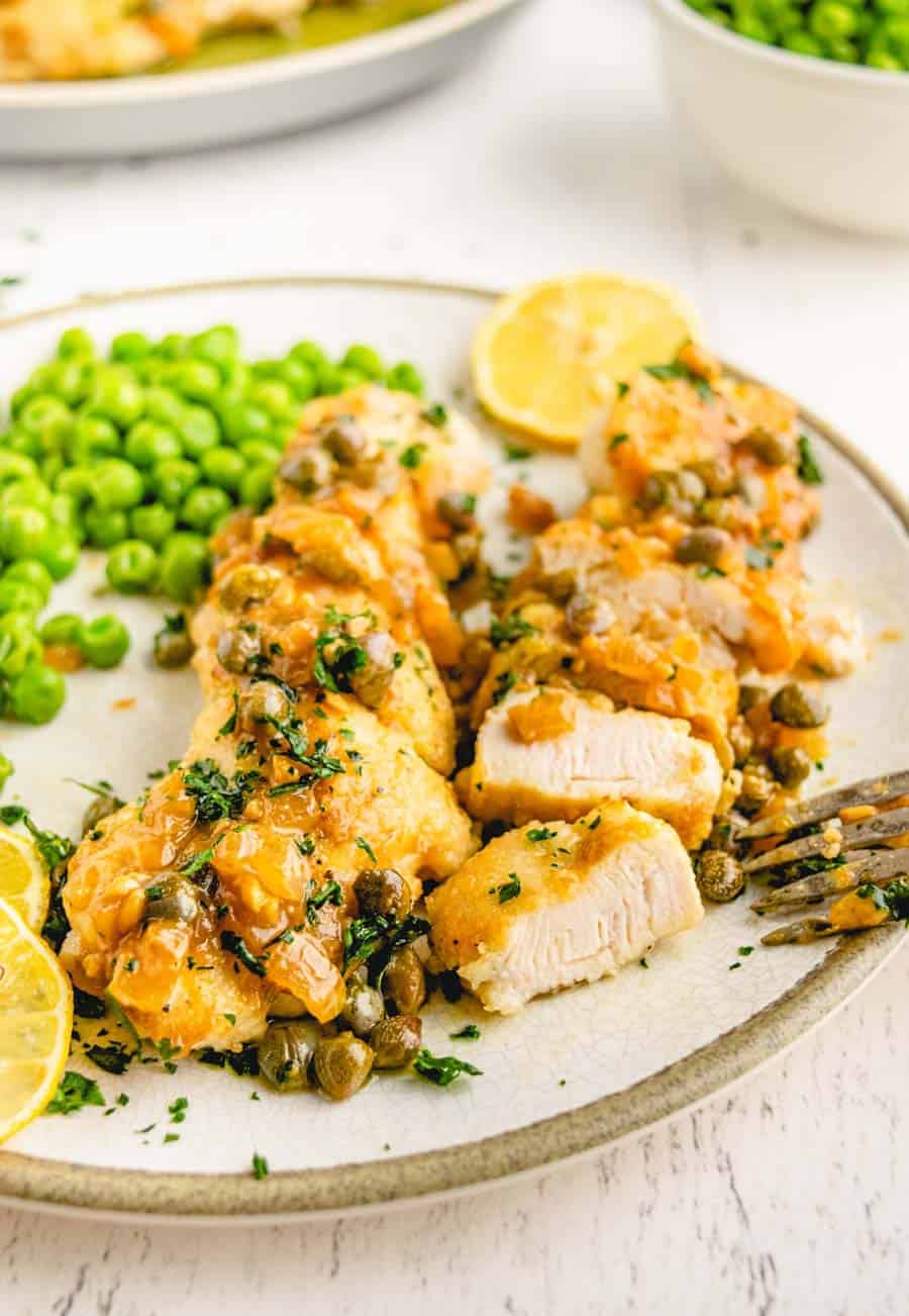 A up close picture of a plate of chicken Picatta.