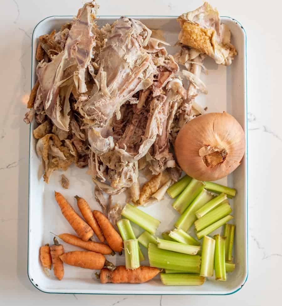 A picture of the ingredients for chicken broth spread out on a baking sheet.
