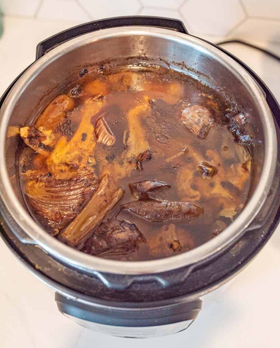 picture of cooked ingredients for chicken broth in an Instant Pot