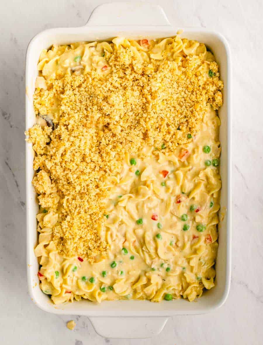 Top view of a baking dish with tuna noodle casserole topped with crushed potato chips.