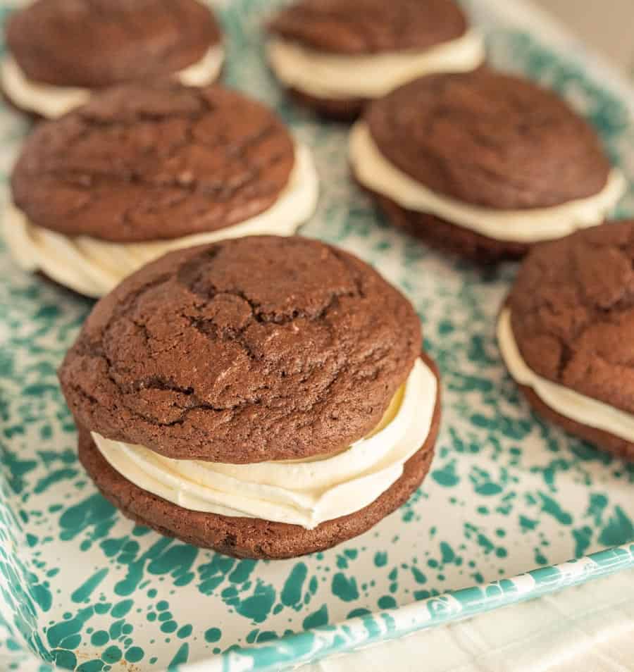 A close up side view of whoopie pies on a teal speckled tray.