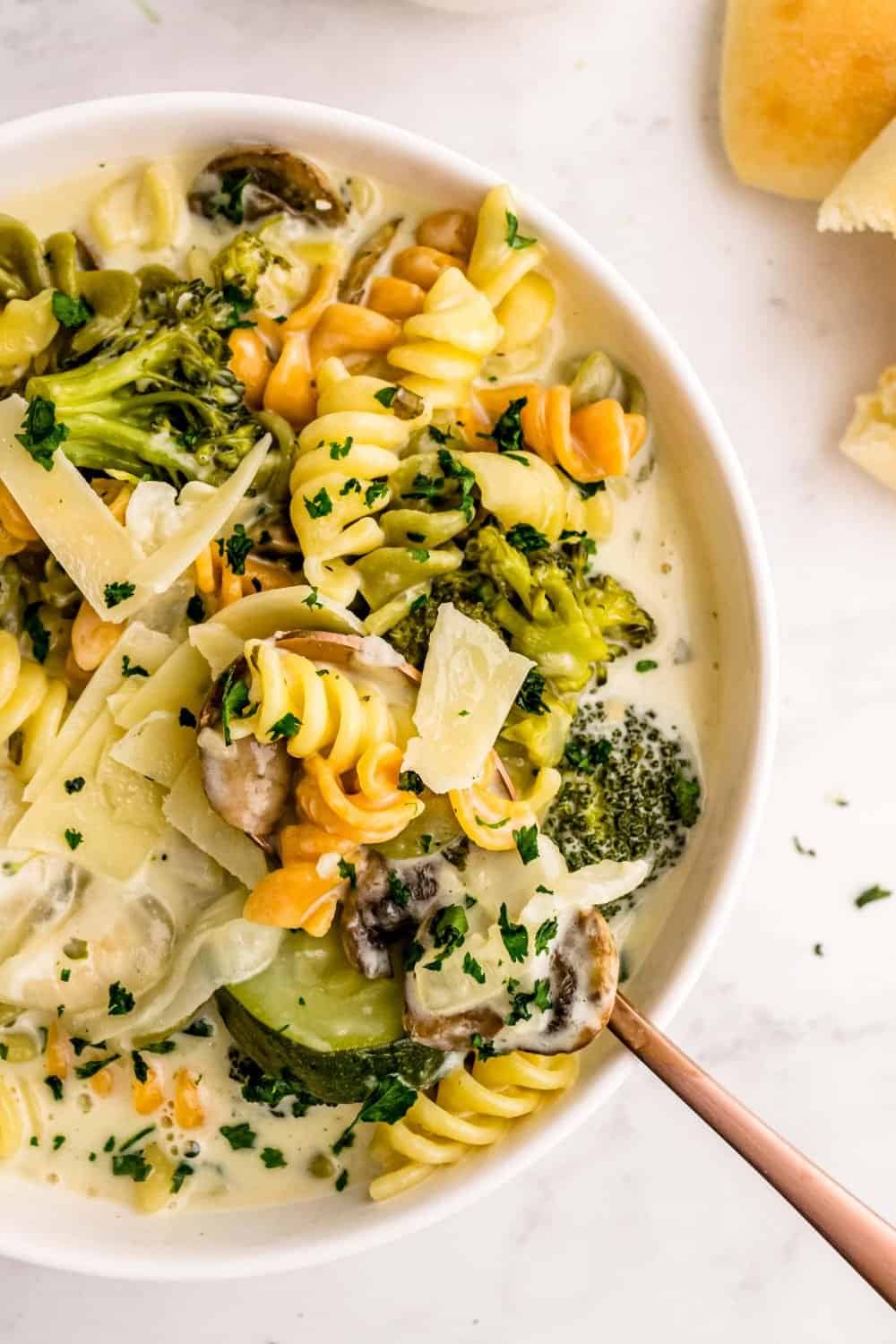 A close up top view of a bowl of pasta primavera.