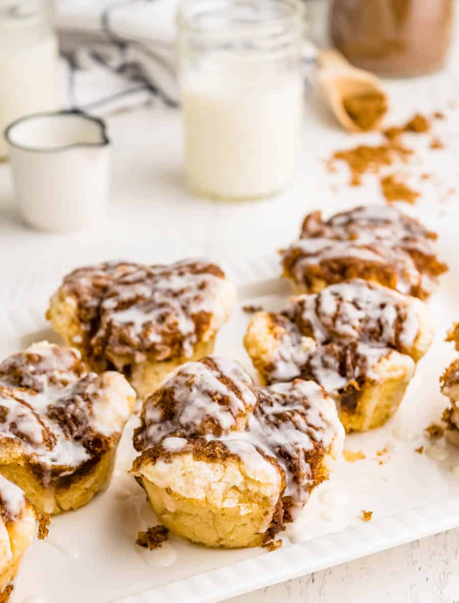 Monkey bread muffins on a tray with a glass of milk in the background.