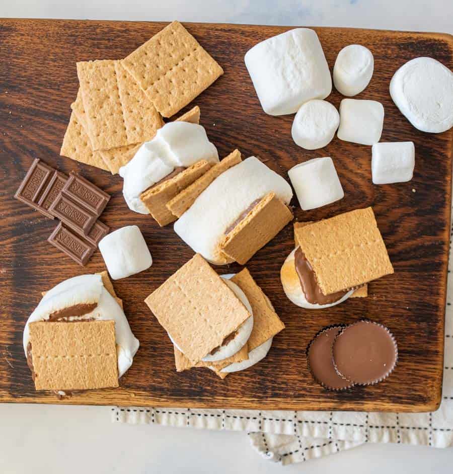 Top view of a wood cutting board with ingredients for smores.