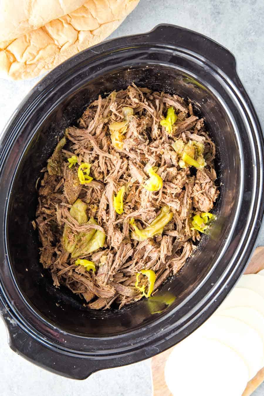 cooked and shredded Italian Beef meat in a slow cooker
