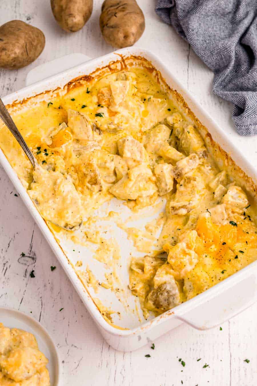 a pan of au gratin potatoes with some already served