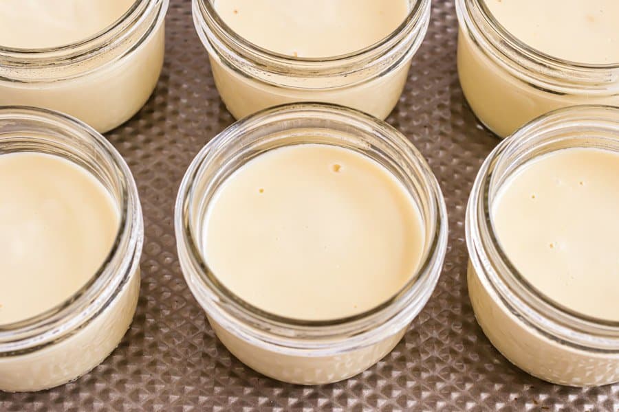 Top view of six jars of vanilla pudding.