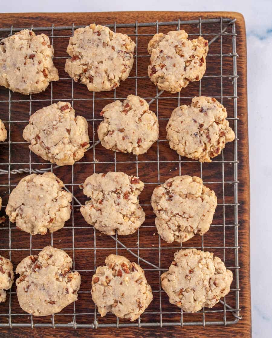 Top view of pecan sandies on a metal cooling rack.