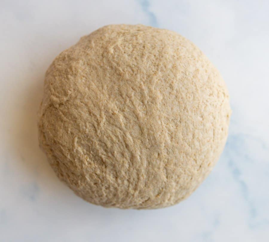 Top view of a ball of whole wheat pizza dough.