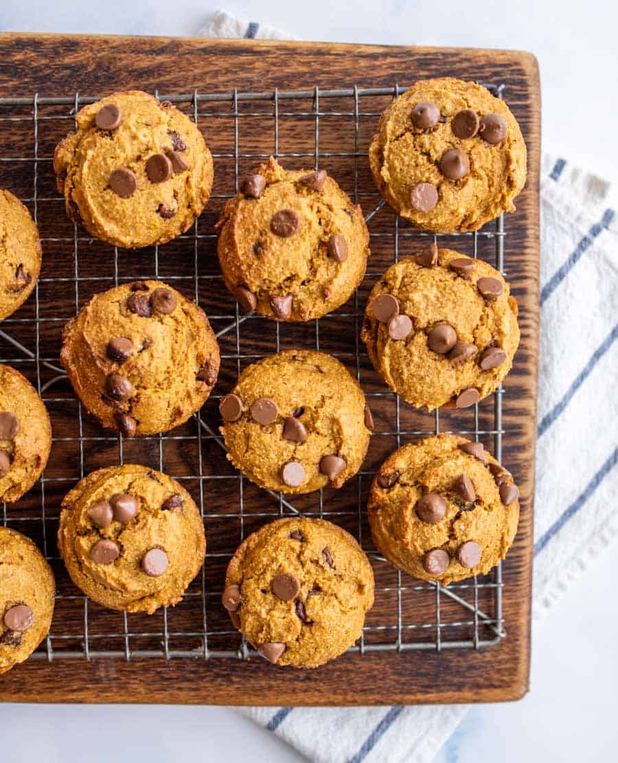 Top view of a cooling rack filled with whole wheat pumpkin muffins.