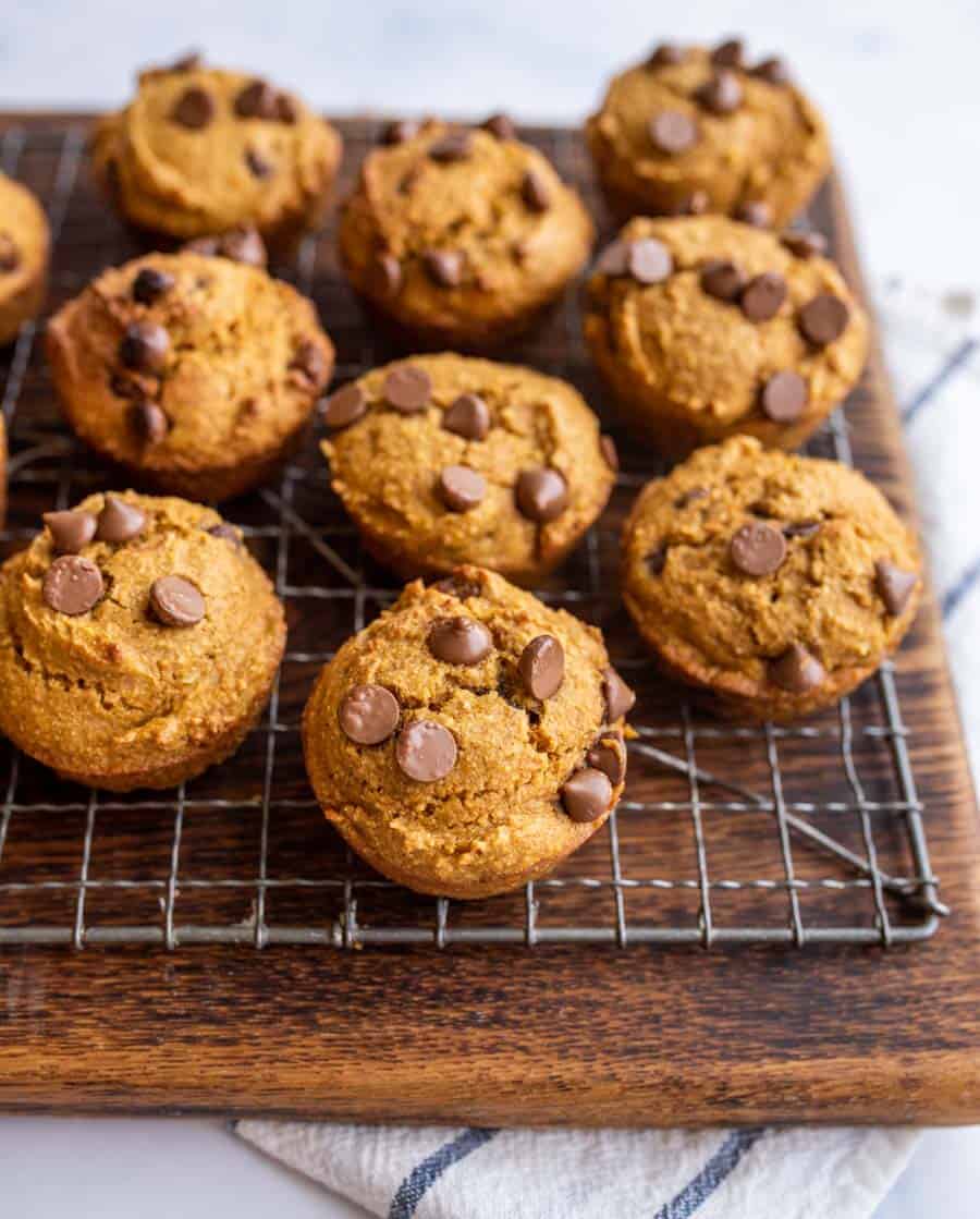 A cooling rack full of whole wheat pumpkin muffins.