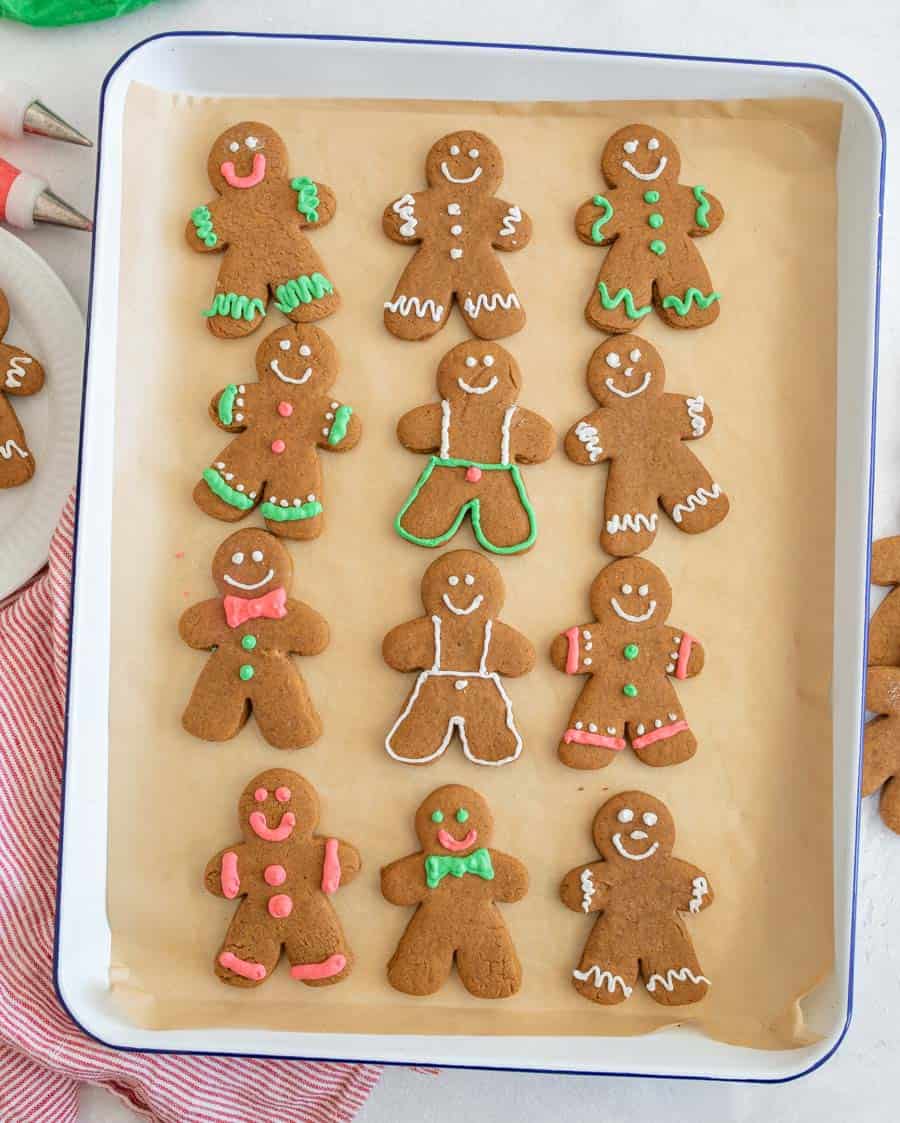 Top view of a sheet of decorated vegan gingerbread cookies.