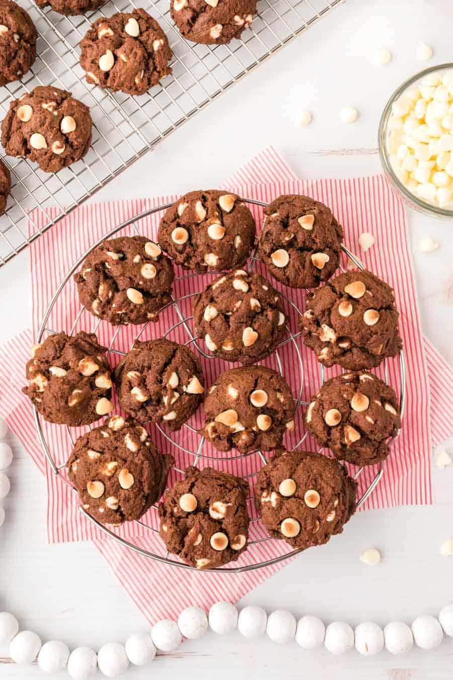 chocolate cookies with white chips on a wire (circle) cooling rack.