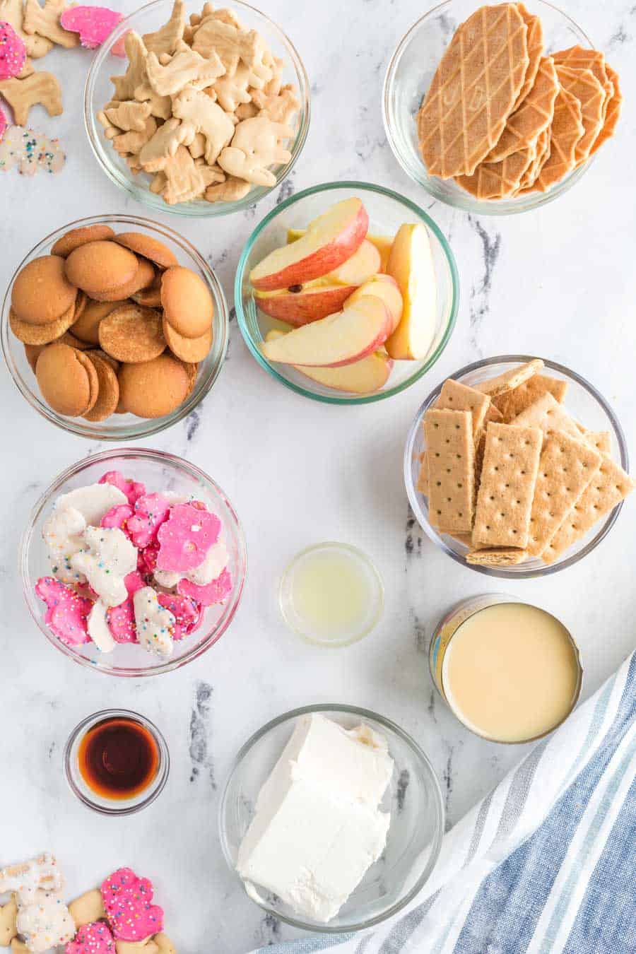 Top view of all the ingredients for cheesecake dip in their own small bowls.