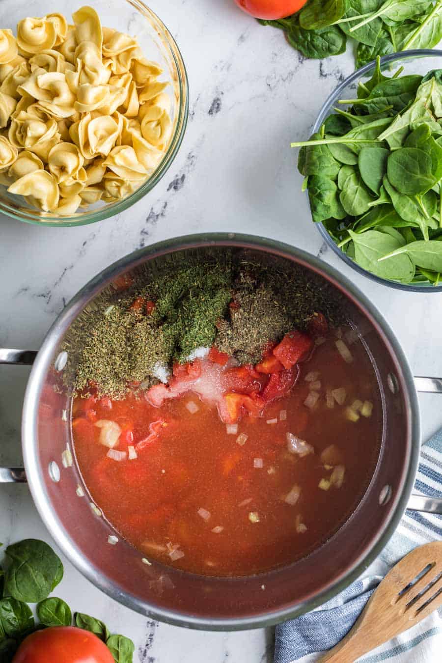 Top view pot with soup stock and spices in side.