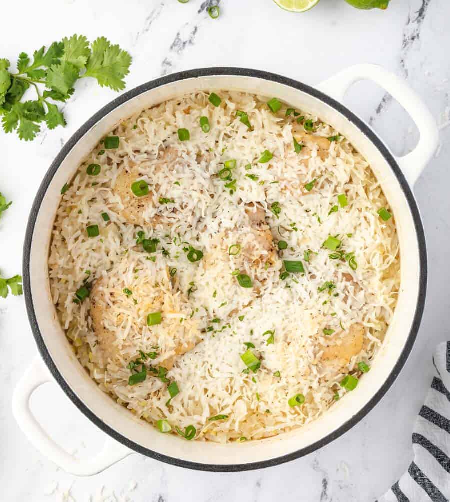 iron pot of rice with green onions garnished on top