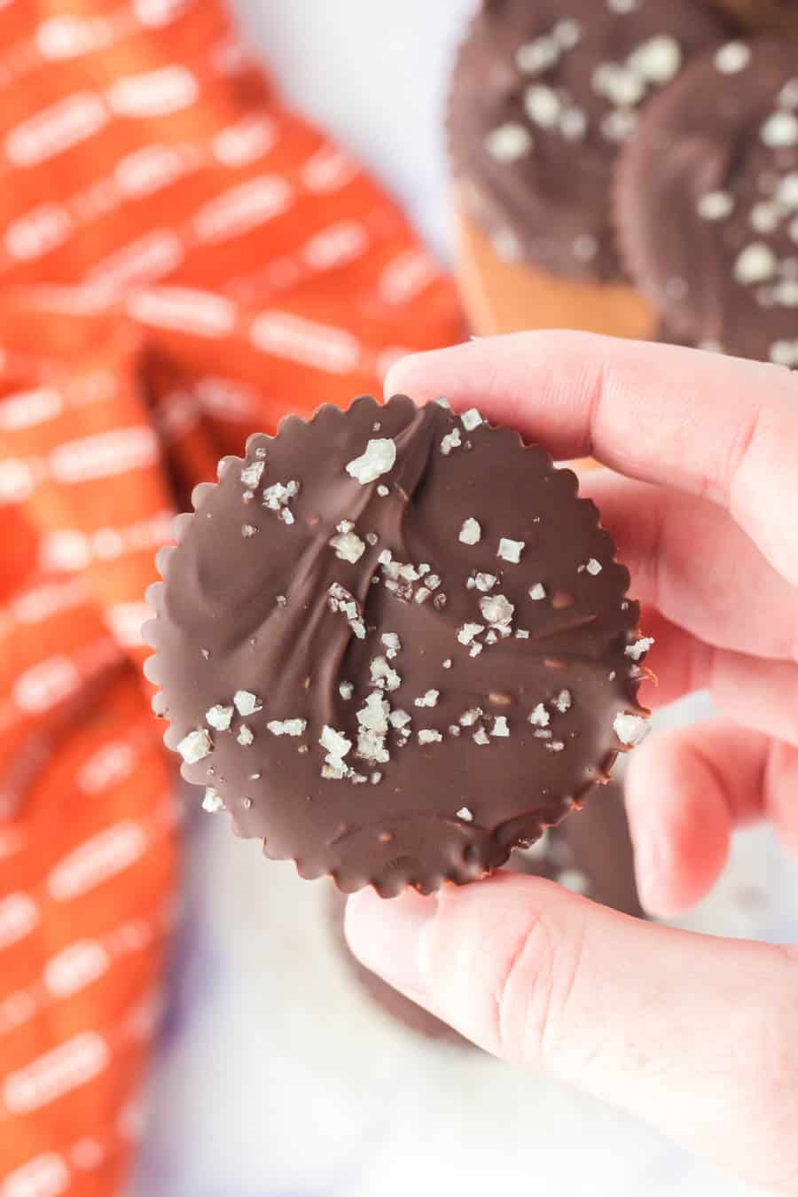 POV hand holding a homemade chocolate peanut butter cups.