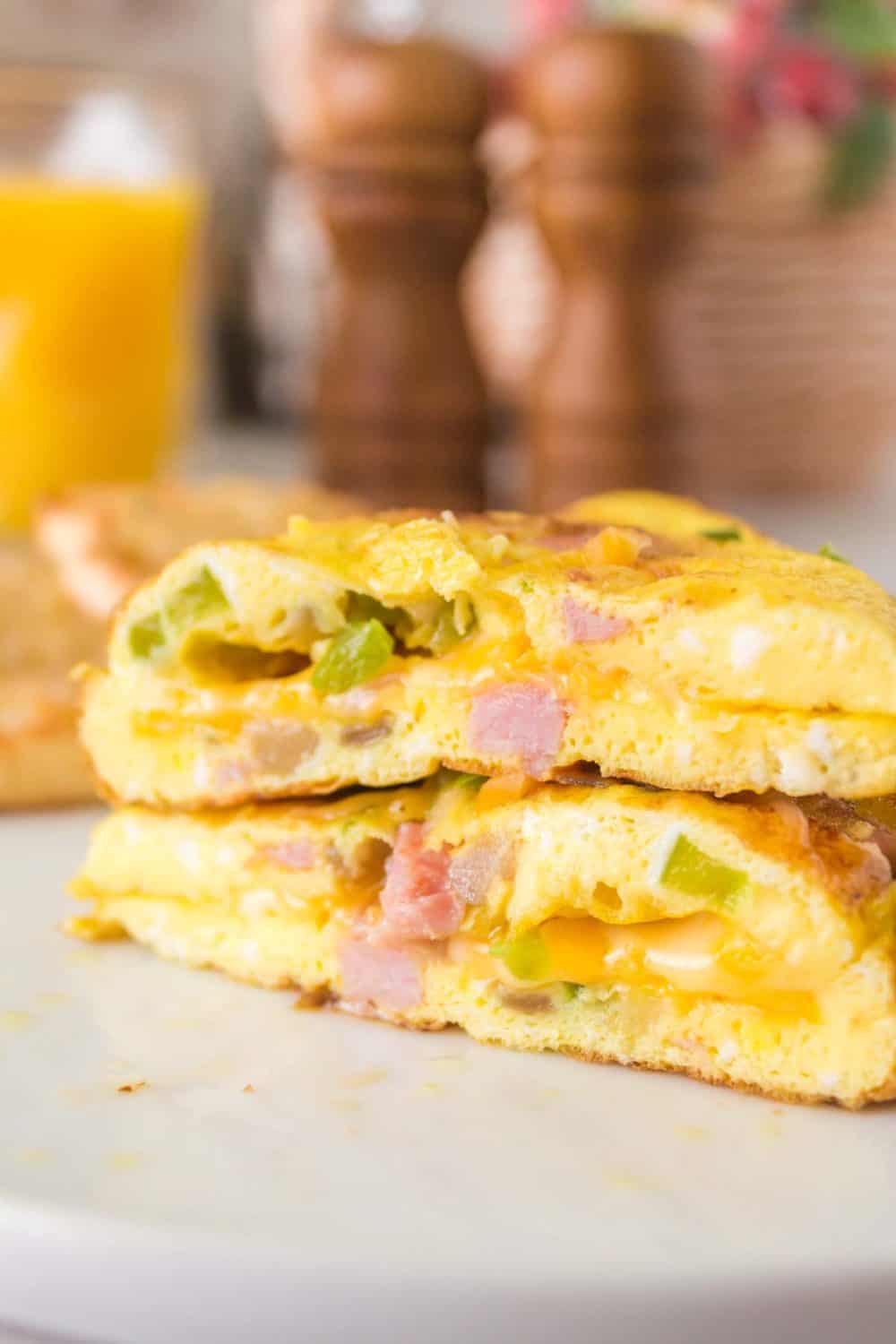 cooked denver omelet cut in half to see the cheesy inside.