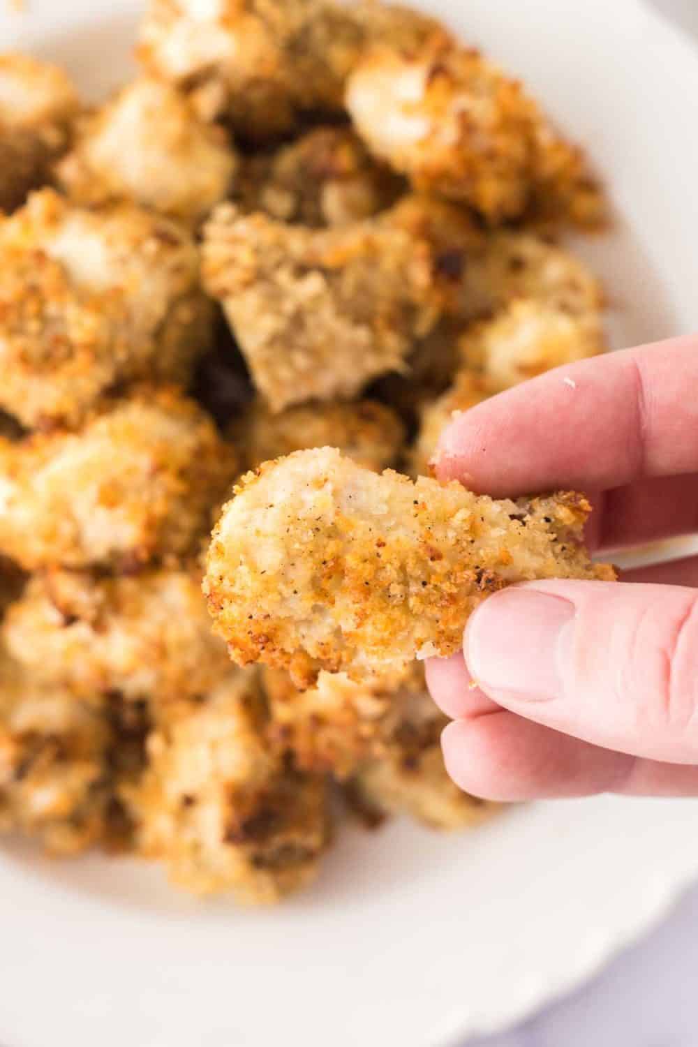 POV holding an air fryer chicken nugget