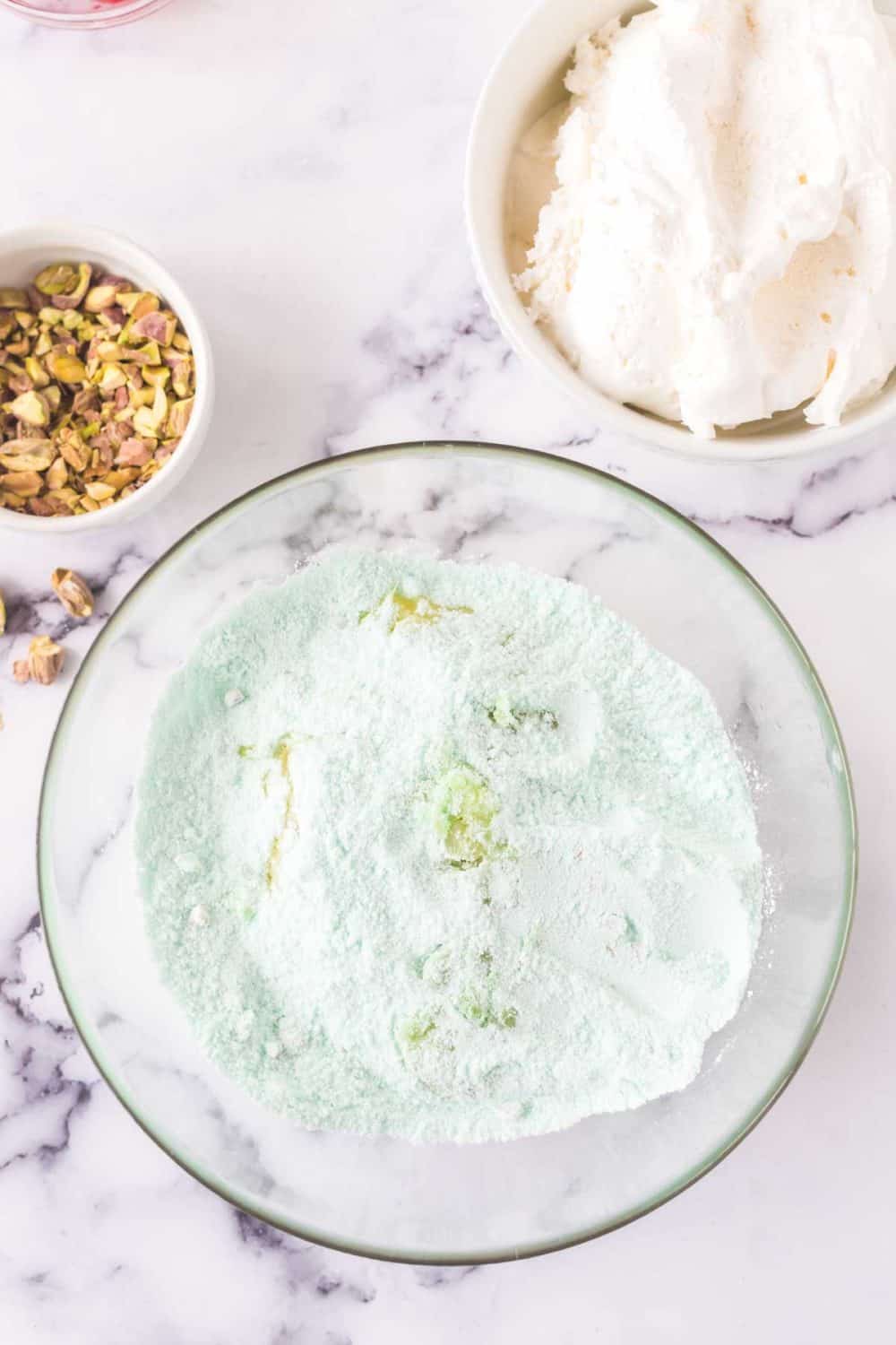 pistachio jello salad ingredients coming together.