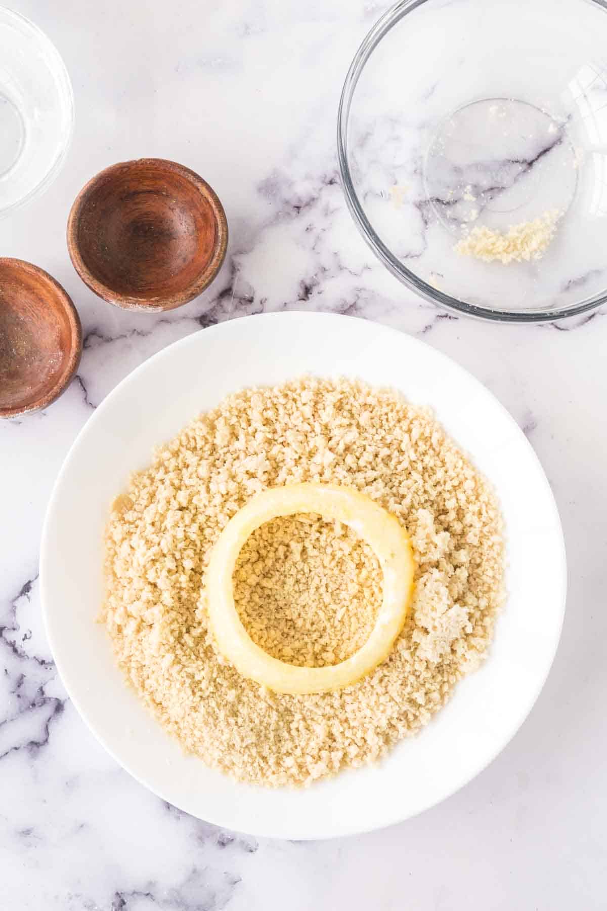 raw onion being breaded.