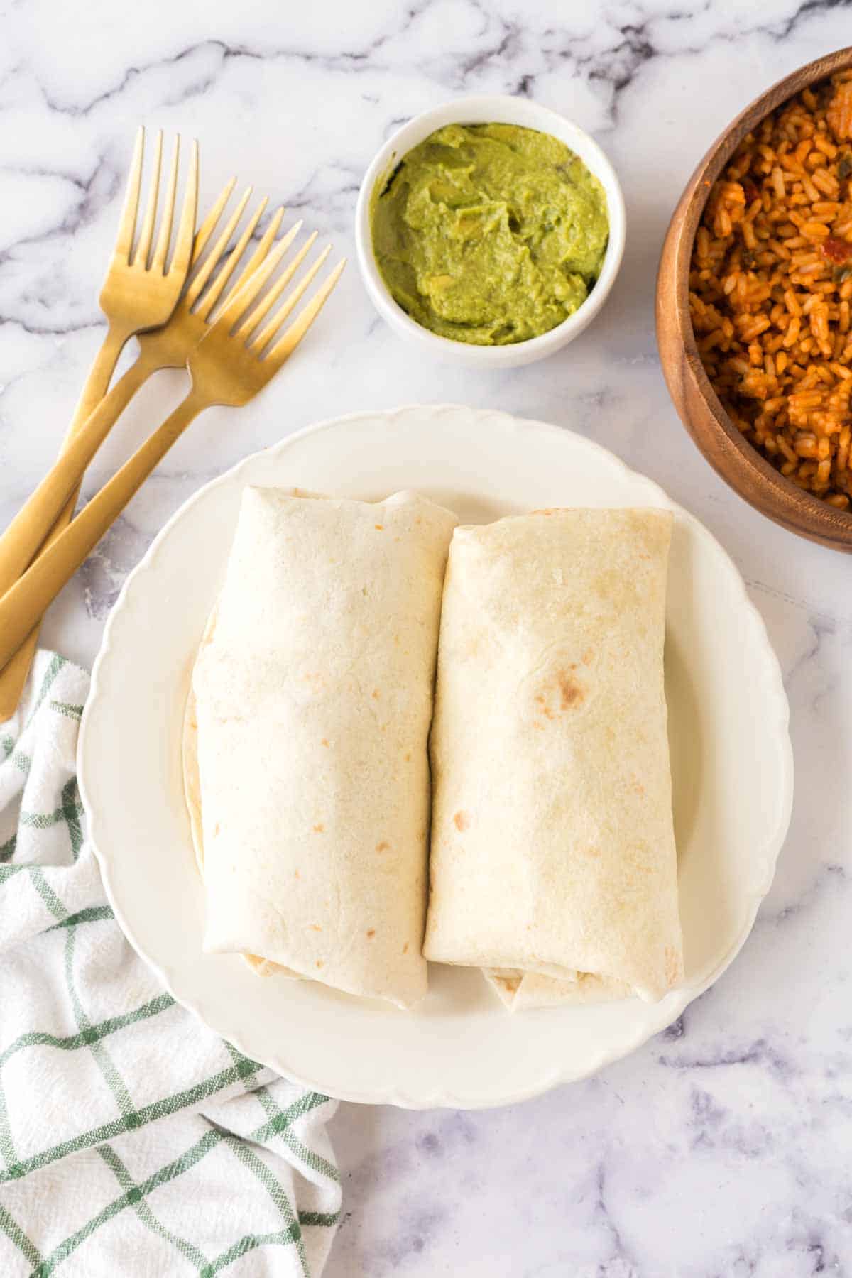 top view whole chicken burritos on a plate