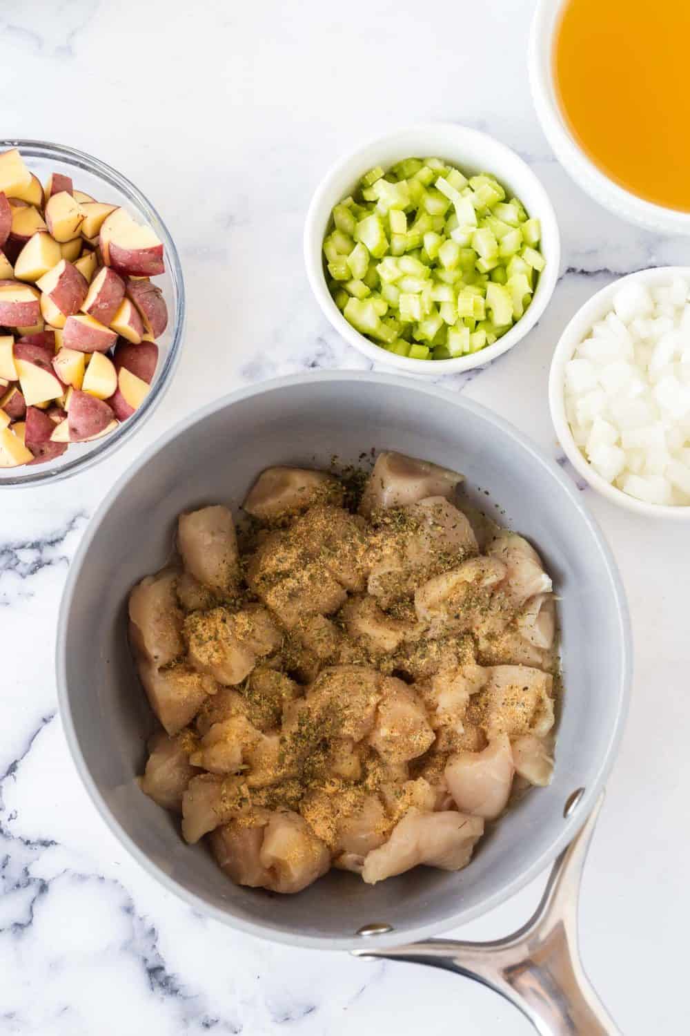 pot of raw chicken stew ingredients