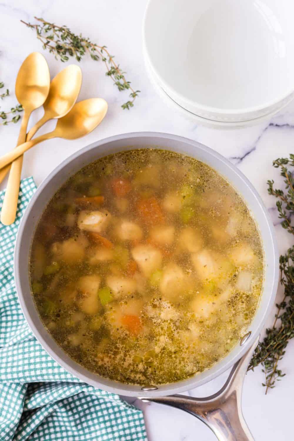 pot of chicken stew reducing top view